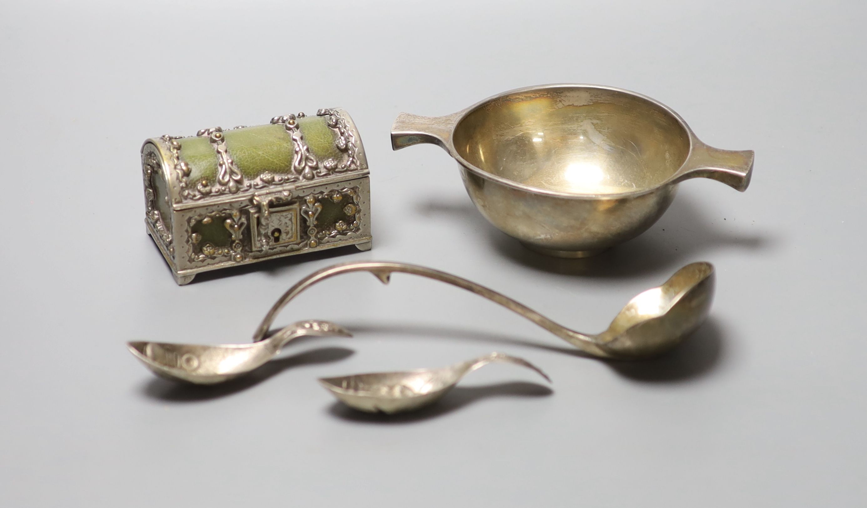 A George V Scottish silver quaich, Edinburgh, 1934, 15.3cm, a plate mounted leatherette casket, two white metal caddy spoons, etc